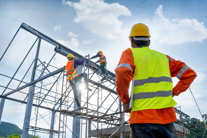 Civil engineer leading workers on a building structure project